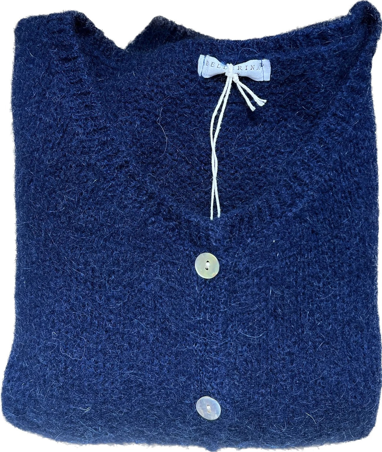 Folded blue knitted cardigan with buttons and a bow detail on a white background