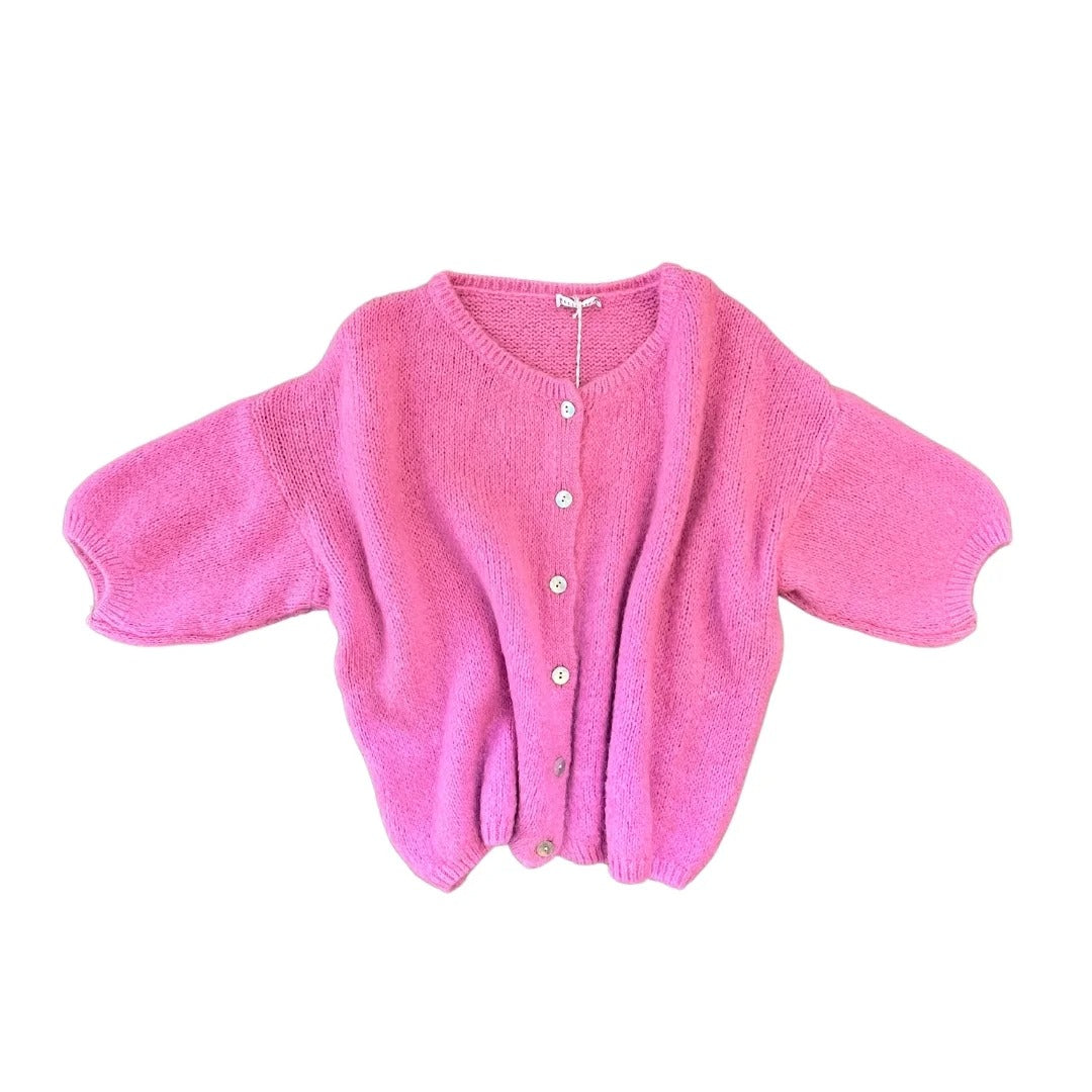 Pink knitted cardigan on a white background
