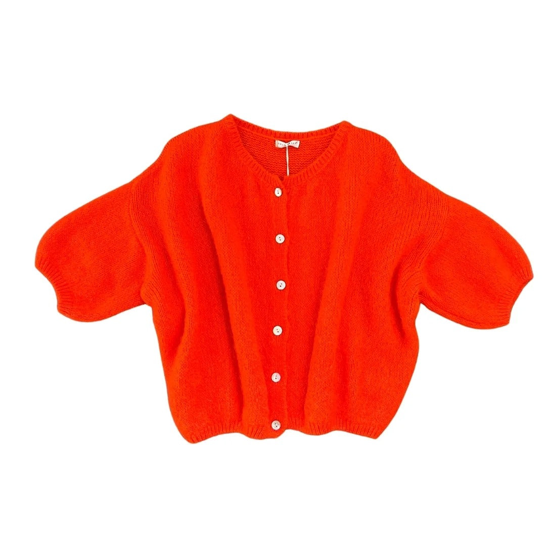 Orange cardigan with button details on a white background