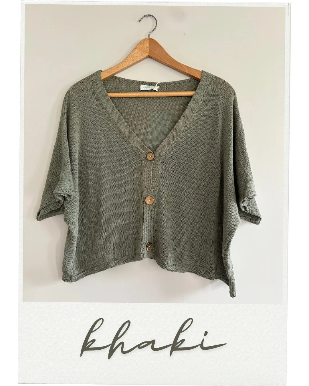 Khaki cardigan on a hanger with 'khaki' text below