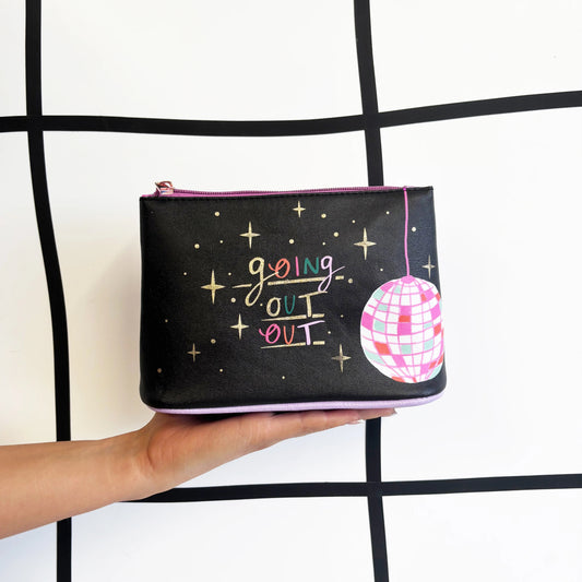 Black pouch with 'going out' text and disco ball design held by a hand against a grid background