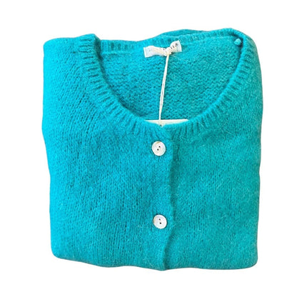 Folded turquoise cardigan with white buttons on a white background