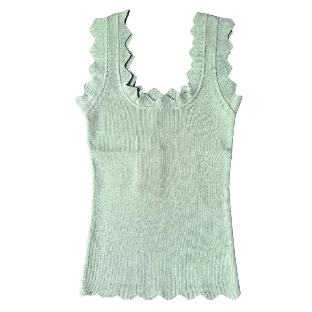 Light green tank top with ruffled neckline on a white background