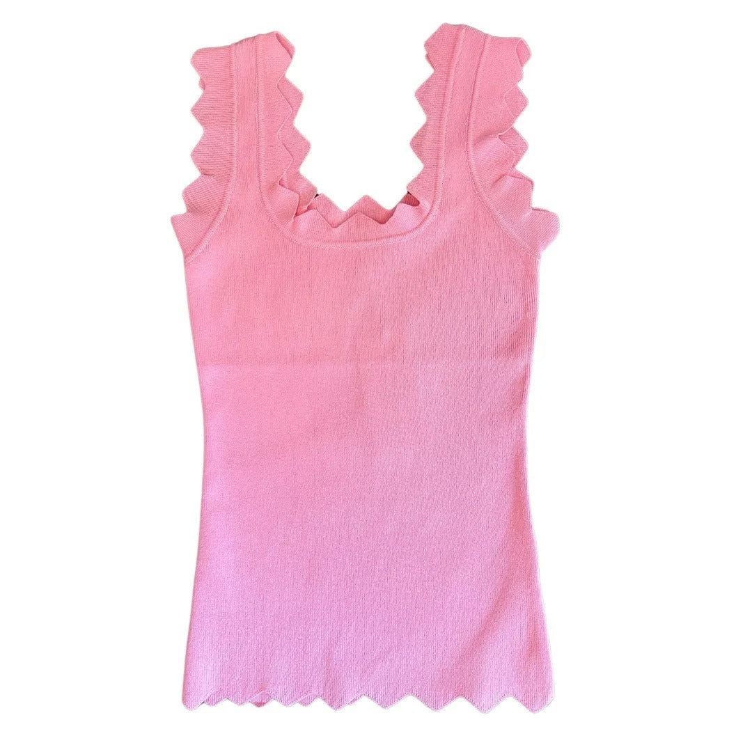 Pink tank top with ruffled straps on a white background