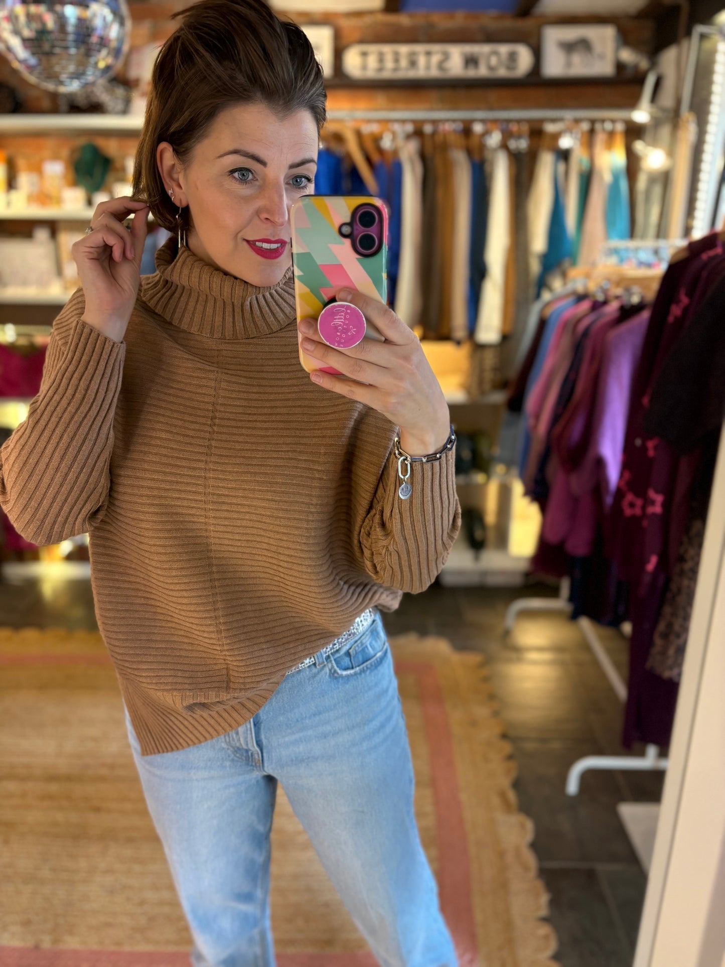 camel brown ribbed long roll neck jumper and light blue jeans