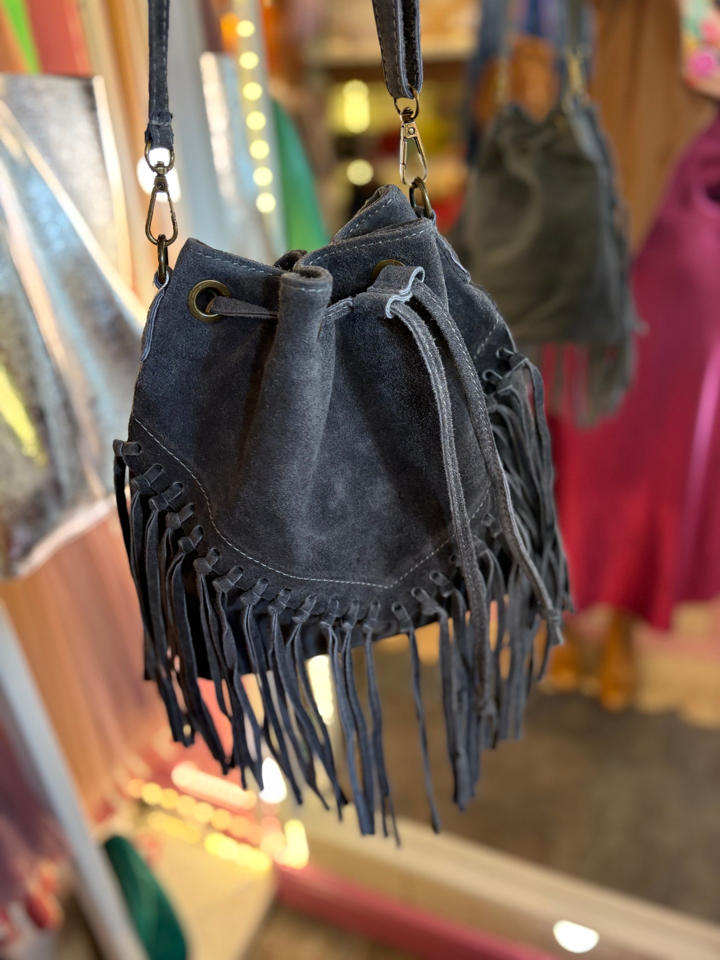 Charcoal Grey suede handbag with fringe details and adjustable strap