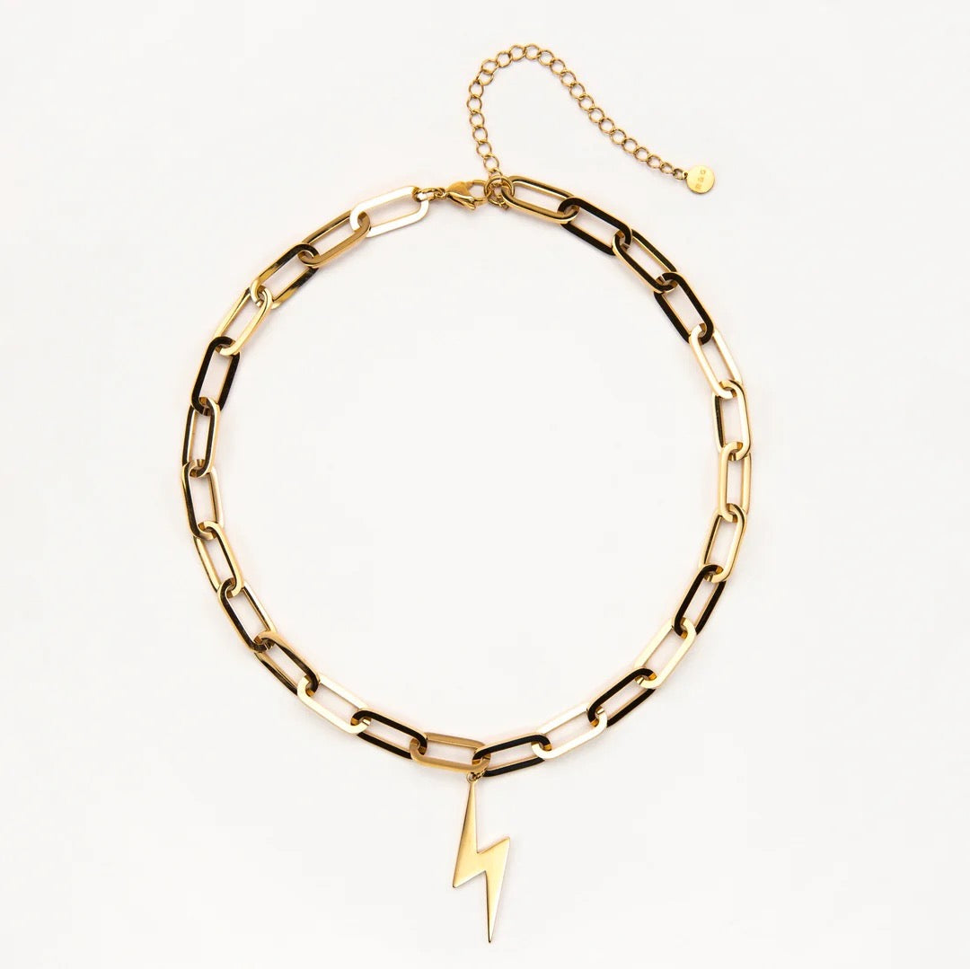 Gold chain bracelet with a lightning bolt charm on a white background