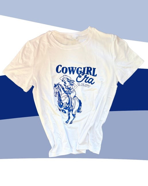 White t-shirt with blue graphic and text 'Cowgirl Era' on a blue and white striped background