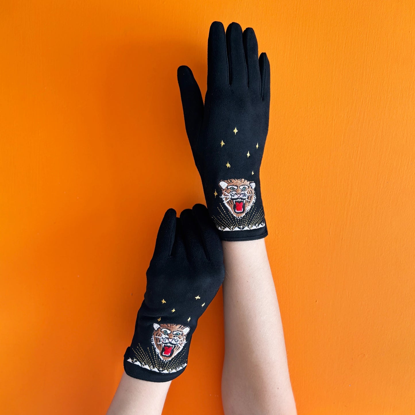 black gloves with an embroidered tiger head design