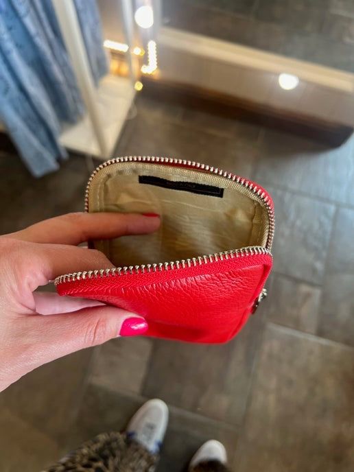 red leather compact handbag the perfect size to hold a mobile phone and some cash, with an adjustable crossbody strap