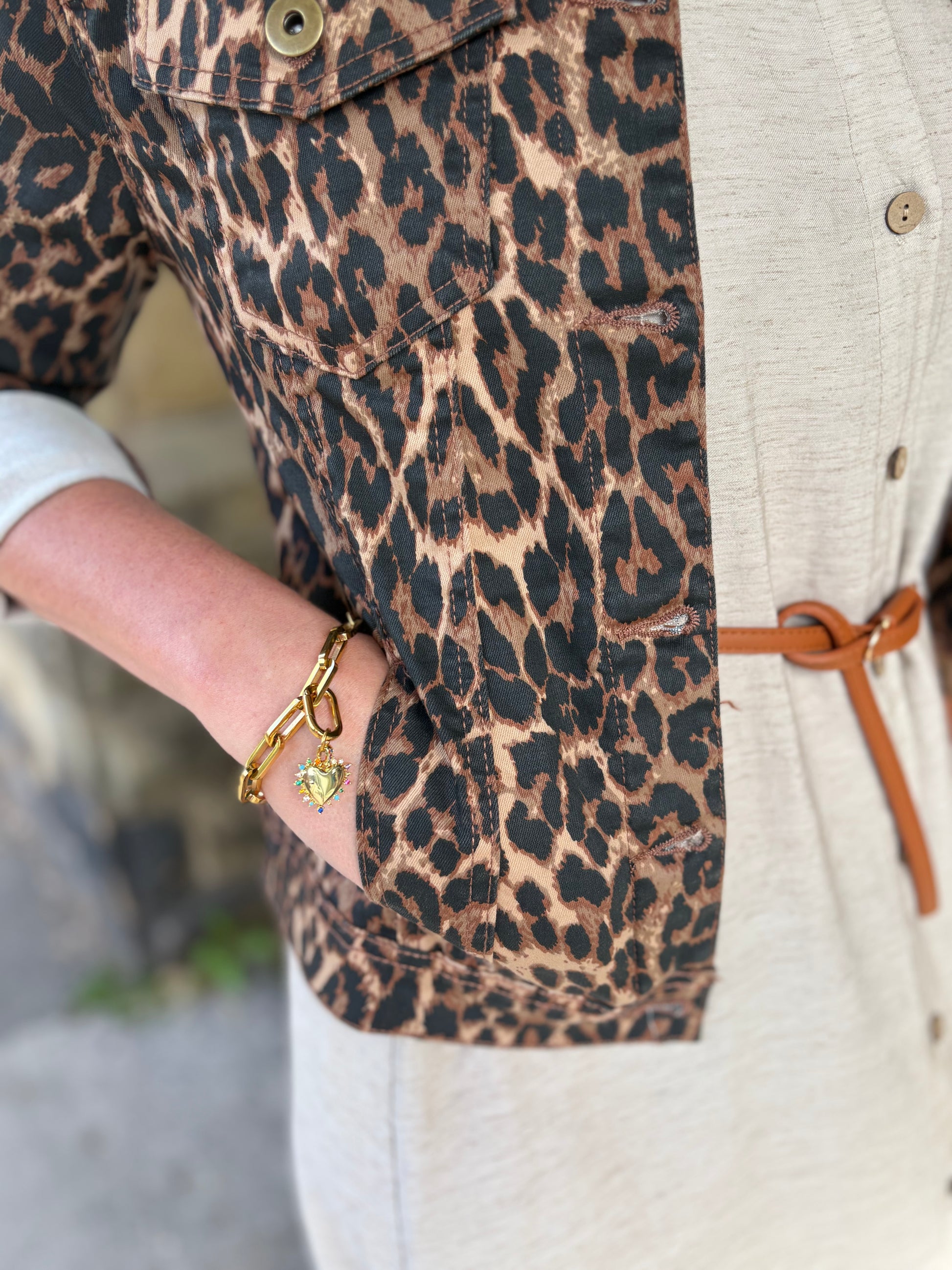 Leopard print jacket worn by a person with a blurred background
