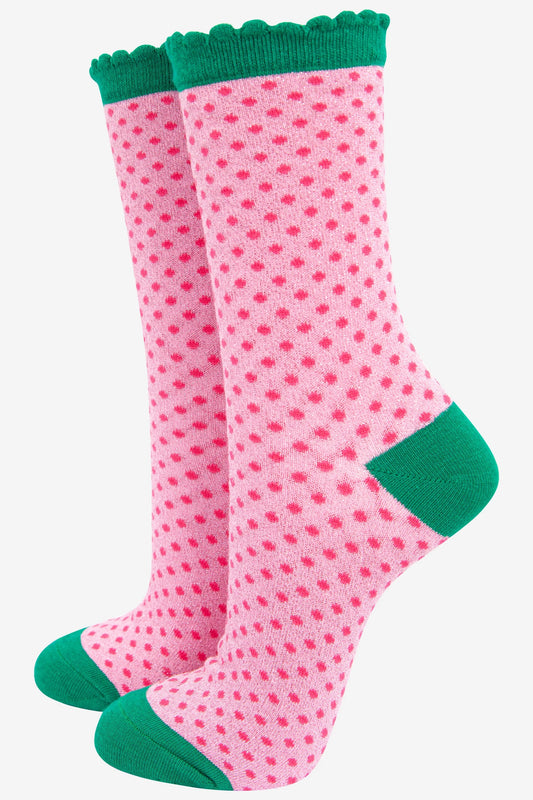 Pink socks with green accents on a white background