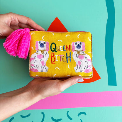 velvet colourful zip pouch with pink tassel and embroidered wording queen bitch with two kitsch Staffordshire dogs illustrated