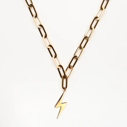 Gold chain necklace with a lightning bolt pendant on a white background