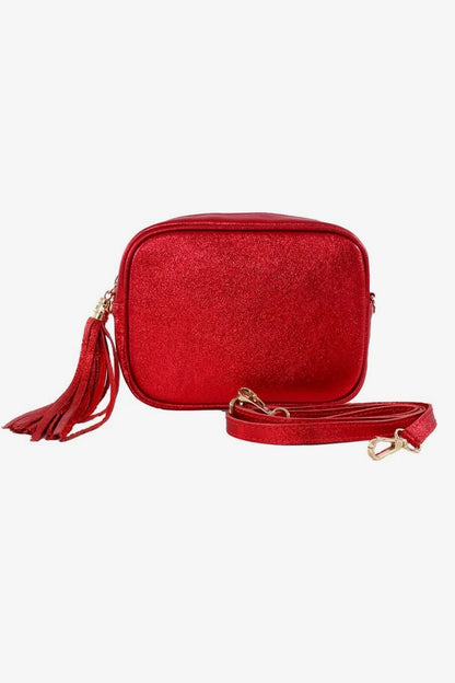 Red crossbody bag with a tassel on a white background