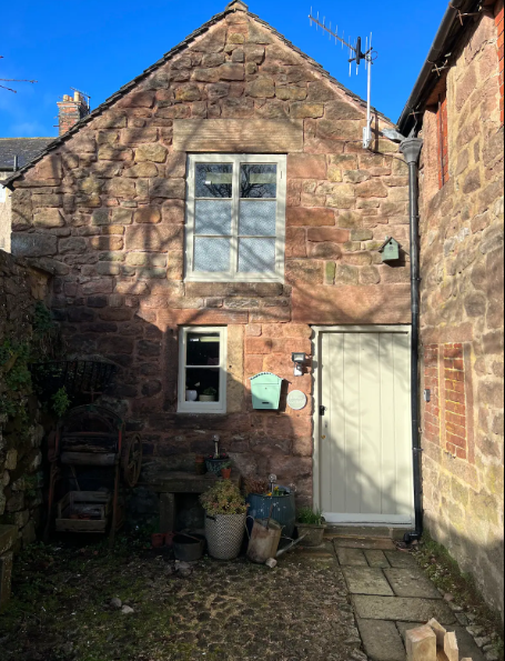 Stone building with a door and windows on a sunny day