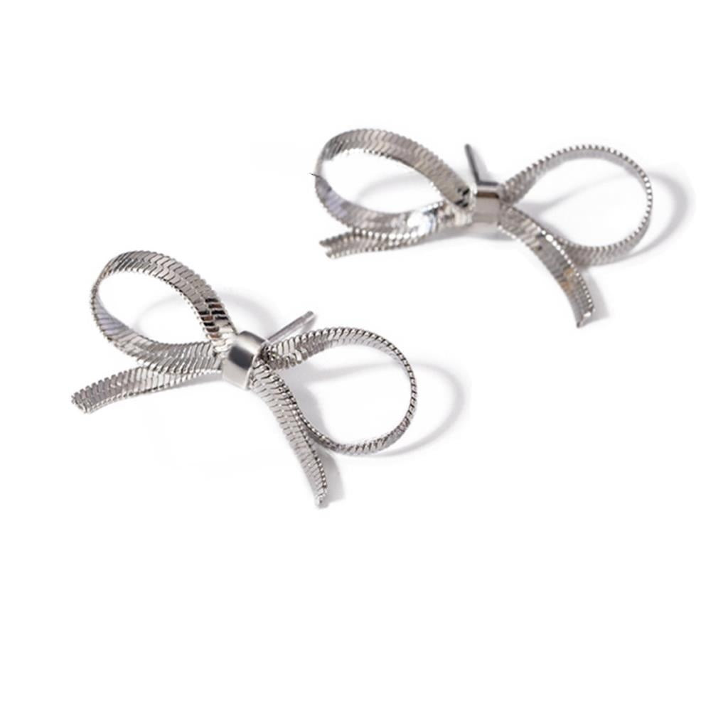 Pair of silver bow-shaped earrings on a white background