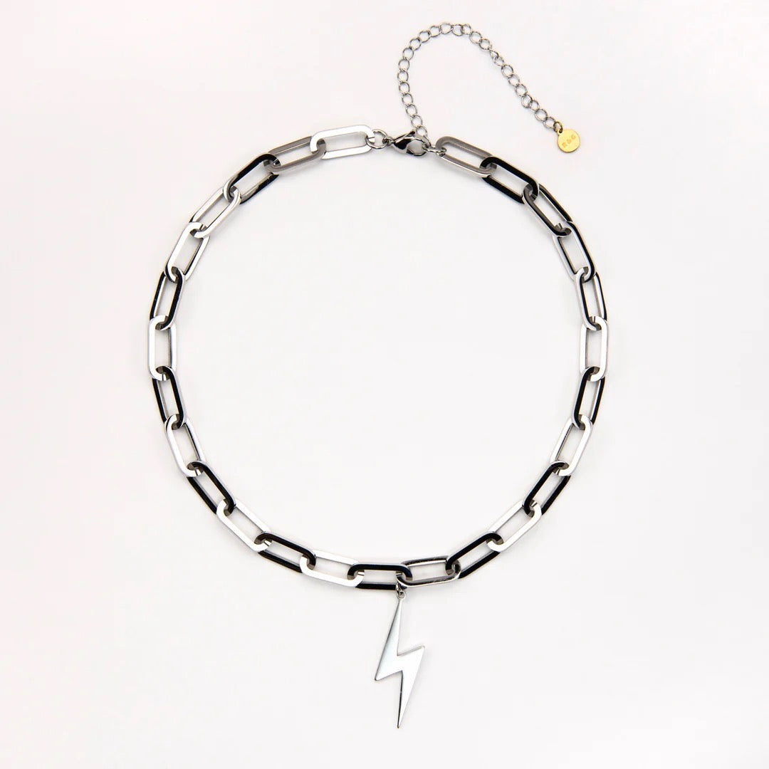 Silver chain necklace with a lightning bolt pendant on a white background