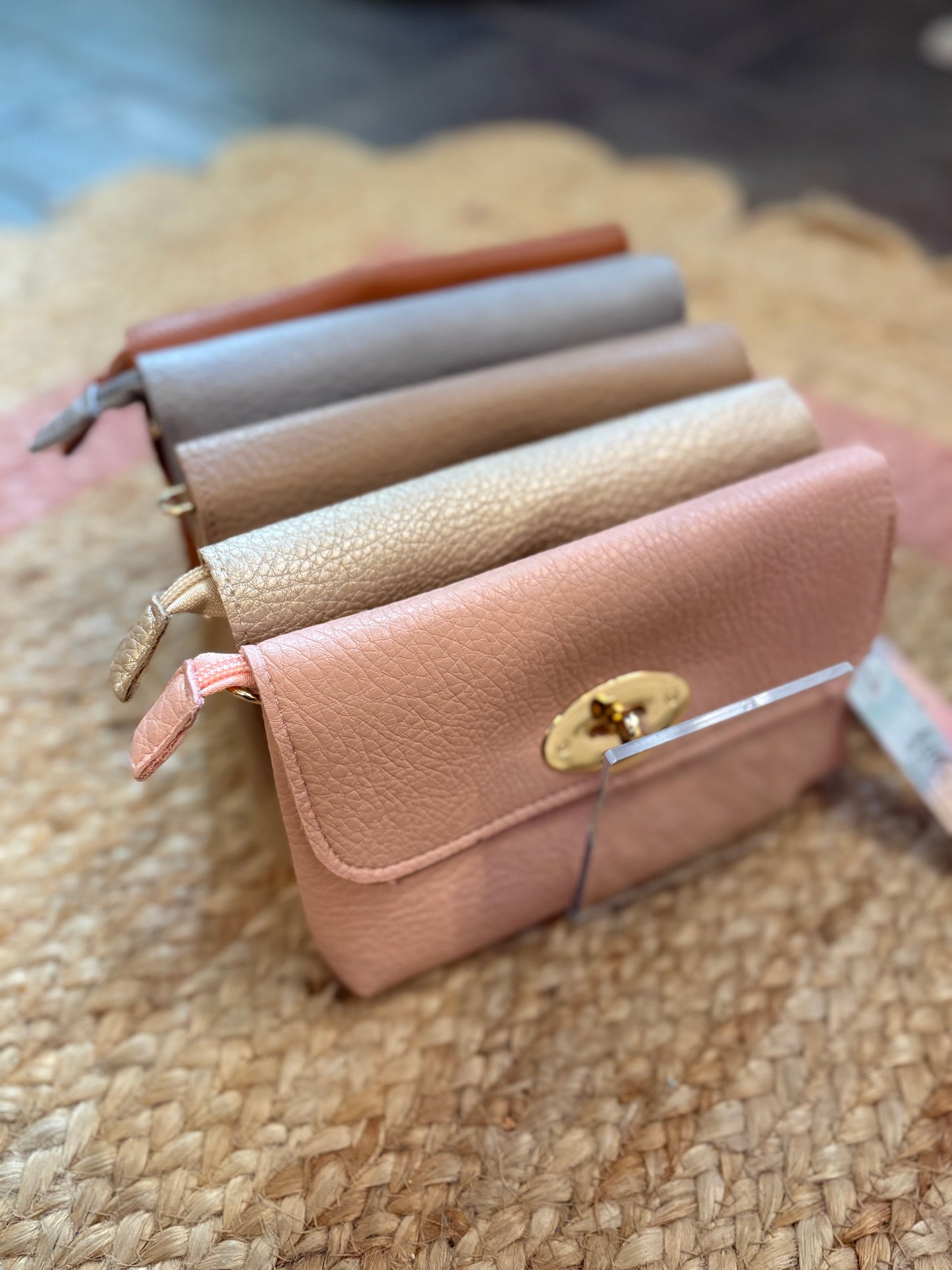Set of small leather bags in various colors on a textured surface